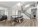 Dining room with high ceiling, staircase, and wooden table and bench at 1979 Lunenburg Dr, Westfield, IN 46074