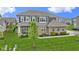 Beautiful two-story home featuring brick and siding, a well-manicured lawn, and professionally landscaped flower beds at 1979 Lunenburg Dr, Westfield, IN 46074