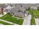 Well-maintained two-story home with a beautifully landscaped yard and covered porch and attached garage at 1979 Lunenburg Dr, Westfield, IN 46074