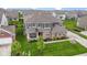 Charming two-story home features a covered front porch, attached two car garage, and a well-manicured lawn at 1979 Lunenburg Dr, Westfield, IN 46074