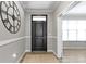 Elegant foyer featuring hardwood floors, a stylish door, and a view into other rooms at 1979 Lunenburg Dr, Westfield, IN 46074