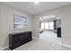 Hallway featuring gray carpet, a painting of the sea, and an entrance to the bedroom at 1979 Lunenburg Dr, Westfield, IN 46074