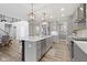 Modern kitchen features an island, stainless steel appliances, and pendant lighting at 1979 Lunenburg Dr, Westfield, IN 46074