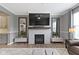 Cozy living room boasts a fireplace, TV, and elegant mirrors, creating a warm atmosphere at 1979 Lunenburg Dr, Westfield, IN 46074