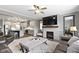 Open-concept living room showcases a fireplace and seamless flow to the modern kitchen at 1979 Lunenburg Dr, Westfield, IN 46074