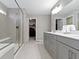 Bright bathroom with glass shower, double sinks, and access to walk-in closet at 1979 Lunenburg Dr, Westfield, IN 46074