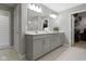 Main bathroom featuring a double sink vanity, large mirror and walk-in closet at 1979 Lunenburg Dr, Westfield, IN 46074