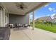 Covered patio with ceiling fan, outdoor seating, and views of the landscaped backyard at 1979 Lunenburg Dr, Westfield, IN 46074