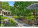 Enjoy outdoor living on this home's back deck with seating and lush landscaping overlooking the large yard at 2011 Pin Oak Ct, Indianapolis, IN 46260