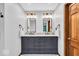 Bathroom features double vanity, granite countertop, wood door, and a decorative rug at 2011 Pin Oak Ct, Indianapolis, IN 46260