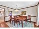 Traditional dining room with wood furnishings, wainscoting, elegant lighting, and views to the kitchen at 2011 Pin Oak Ct, Indianapolis, IN 46260