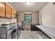 Functional laundry room with modern appliances, storage shelves, and patterned floor at 2011 Pin Oak Ct, Indianapolis, IN 46260