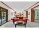 Open-concept living room with wood trim, carpet, and views of the kitchen at 2011 Pin Oak Ct, Indianapolis, IN 46260