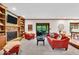 Bright living room featuring a stone fireplace, built-in bookshelves, and sliding glass doors at 2011 Pin Oak Ct, Indianapolis, IN 46260