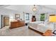 Spacious main bedroom features vaulted ceiling, carpeted floor, dresser, and bed with luxury bedding at 2011 Pin Oak Ct, Indianapolis, IN 46260
