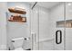 Modern shower features white tile, glass door, built in marble bench, and decorative wood shelving at 2011 Pin Oak Ct, Indianapolis, IN 46260