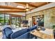 Sunroom with stone accent wall, wood-paneled ceiling, and access to the outdoors at 2011 Pin Oak Ct, Indianapolis, IN 46260