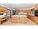 Spacious kitchen featuring an island, custom cabinetry, stainless steel appliances, and tiled floors at 2308 Galahad Dr, Indianapolis, IN 46228