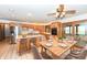 Open kitchen and dining area featuring wooden cabinetry, stainless steel appliances, and bar seating at 2308 Galahad Dr, Indianapolis, IN 46228