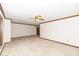 A bright living room features neutral carpeting and is equipped with a ceiling fan at 2308 Galahad Dr, Indianapolis, IN 46228