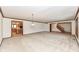 Large living room with plush carpeting, chandelier, and open access to the kitchen and staircase at 2308 Galahad Dr, Indianapolis, IN 46228