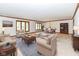 Inviting living room with neutral decor, wood trim, plush seating, and adjacent dining area for seamless entertaining at 2308 Galahad Dr, Indianapolis, IN 46228