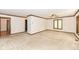 Bright living room with neutral carpeting, wood trim, and a ceiling fan at 2308 Galahad Dr, Indianapolis, IN 46228