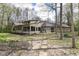 Back of the home with a screened in sunroom, patio, and lush backyard at 2308 Galahad Dr, Indianapolis, IN 46228