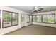 Cozy sunroom with light colored wall paneling and views of mature trees at 2308 Galahad Dr, Indianapolis, IN 46228