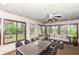 Bright sunroom with large windows offering views of the backyard, plus a table, chairs, and sofa at 2308 Galahad Dr, Indianapolis, IN 46228