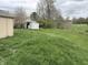 Large grassy backyard with two sheds, mature trees, and open space at 2632 Walker Ave, Indianapolis, IN 46203