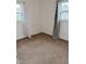 Neutral bedroom with two windows, wall outlets, and neutral carpet at 2632 Walker Ave, Indianapolis, IN 46203