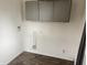 Dedicated laundry area with overhead cabinets and utility connections for added convenience at 2632 Walker Ave, Indianapolis, IN 46203