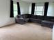 Spacious living room featuring neutral carpet, a large sofa, and natural light from the windows at 2632 Walker Ave, Indianapolis, IN 46203