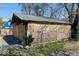 Exterior view of a dilapidated garage with boarded-up walls, showing potential for renovation at 3320 E New York St, Indianapolis, IN 46201