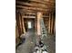 Unfinished room with exposed framing and ladder, emphasizing renovation potential and design opportunities at 3320 E New York St, Indianapolis, IN 46201