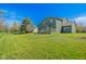 Sprawling backyard showcasing lush green lawn and a well-maintained exterior of the home with a deck at 358 W Tansey Xing, Westfield, IN 46074