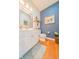 Stylish powder room features bright lighting, modern fixtures, and unique wallpaper at 358 W Tansey Xing, Westfield, IN 46074