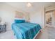 Cozy bedroom with natural light, featuring neutral walls and carpet, and bright blue accents at 358 W Tansey Xing, Westfield, IN 46074