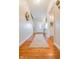Bright foyer with hardwood floors, a decorative rug, and a view into the powder room at 358 W Tansey Xing, Westfield, IN 46074