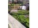 View of backyard with shed and foliage; deck railing is in the foreground at 38 Homestead Dr, Sheridan, IN 46069