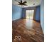 Primary bedroom with laminate flooring, a ceiling fan and sliding glass doors at 38 Homestead Dr, Sheridan, IN 46069