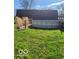 Outdoor above ground pool with a lush grassy yard and decorative plants at 38 Homestead Dr, Sheridan, IN 46069