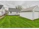 The backyard showcases a detached garage and green lawn, offering space and convenience at 3826 Delaware St, Anderson, IN 46013