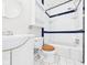 Bathroom with blue and white tile, white cabinets, and a wooden toilet seat at 3826 Delaware St, Anderson, IN 46013
