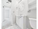 Compact bathroom with vanity, toilet, and white tile flooring, offering a practical design at 3826 Delaware St, Anderson, IN 46013