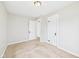 This bedroom features neutral walls, tan carpet, and classic white trim with two doors at 3826 Delaware St, Anderson, IN 46013
