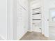 View of hallway showing cabinets and access to the bathroom with tiled tub and shower at 3826 Delaware St, Anderson, IN 46013