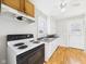 Cozy kitchen with white and wood cabinets and standard appliances at 3826 Delaware St, Anderson, IN 46013