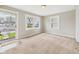 Inviting living room with carpet, front door entrance, and double windows at 3826 Delaware St, Anderson, IN 46013